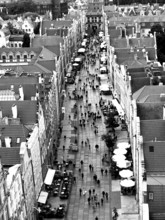 Aerial view of a busy urban street lined with historic buildings in black and white, view from St.