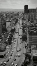 Urban scene in black and white with high-rise buildings and busy road. Pristina, Kosovo