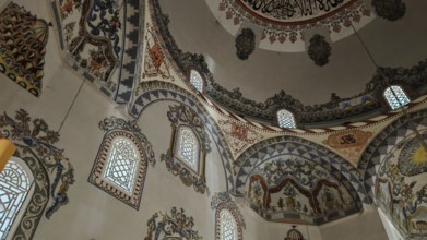 A magnificently decorated interior of a dome with rich ornaments and light-filled windows, Prizren,