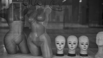 Shop window with mannequins and heads in a melancholy black and white atmosphere, Skopje, Macedonia