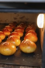 Pretzel rolls are baked in the oven with salt, golden brown surface, bake rolls, Haselstaller Hof,