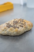 Crispy baked roll with seeds on a metal surface, bake rolls, Haselstaller Hof, Gechingen, Germany
