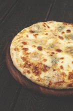 Freshly baked cheese pizza, with a golden crust and bubbling melted cheese, white pizza, on a