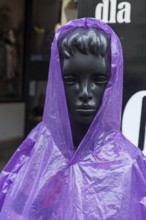 Window mannequin with rain cape in rain, Krakow, Poland