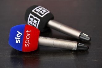 Two microphones are lying on the table, competition, competitor channel, logo, SKY, DAZN, soccer