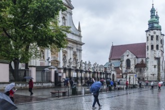 Sculptures of saints in front of St. Peter and Paul Church, St. Andrew's Church on the right,