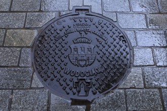 Manhole cover with the coat of arms of Krakow, Krakow, Poland