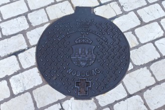 Manhole cover with the coat of arms of Krakow, Krakow, Poland
