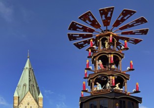 Christmas market with mulled wine pyramid and the tower of Paderborn Cathedral, Ostwestfalen-Lippe,