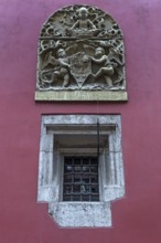 Relief with coat of arms and angels on a coloured house wall, Krakow, Poland