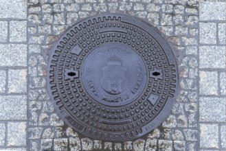 Manhole cover with the coat of arms of Krakow, Krakow, Poland