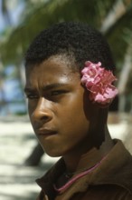 Boy with flowers behind left ear, Tavewa Island, Yasawa archipelago, Fiji