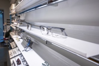 Elegant eyeglass shelf with clear glasses in a modern showroom, optician, Pforzheim