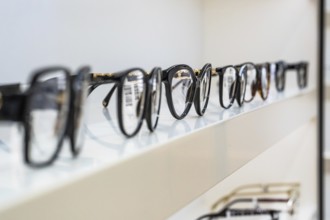 Row of eyeglass frames on a shelf in an optician's shop, optician, Pforzheim