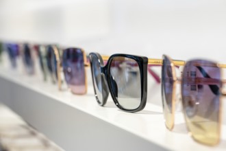 Set of sunglasses in different colors on a shelf, optician, Pforzheim