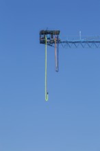 Montreal Bungee Tower installation with dangling long yellow elastic bungee jumping cord, Old Port