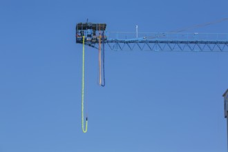 Montreal Bungee Tower installation with dangling long yellow elastic bungee jumping cord, Old Port