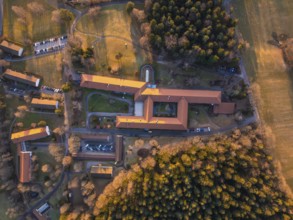 Bird's eye view of a sprawling complex with red roofs and forests, Rehab Clinic, Schömberg, Black