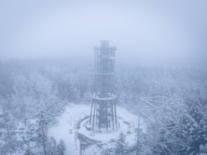 A lonely tower stands in a foggy, snowy forest, Himmelsglück observation tower with Flying Fox,
