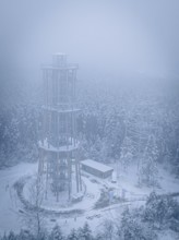 A foggy, snow-covered treetop trail rises in the winter landscape, Himmelsglück observation tower