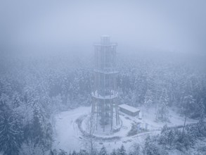 A treetop trail in a foggy, snowy winter landscape from above, Himmelsglück observation tower with