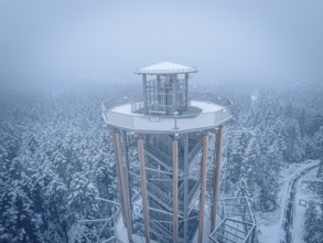 Snow-covered tower above a winter forest in fog, Himmelsglück observation tower with Flying Fox,
