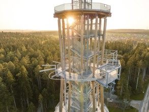 Spire at setting sun surrounded by thick forests, Himmelsglück observation tower with Flying Fox,