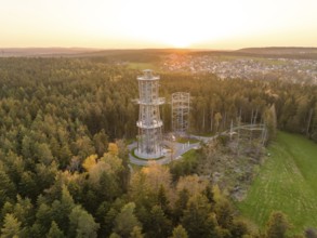 Wide view of the forest with tower and adjacent village in the evening light, Himmelsglück