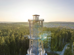 High observation tower in a wooded area at sunset with a view over the valley, Himmelsglück