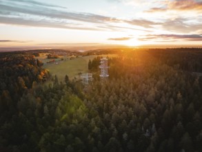 Sunset behind an observation tower in the middle of a vast forest, Himmelsglück observation tower