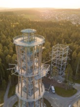 A modern observation tower in a sunny forest offers a view of the city, Himmelsglück observation