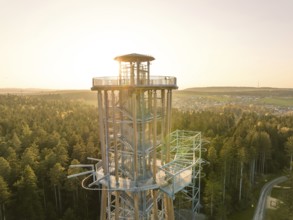 Detailed view of a modern tower, sunlight penetrating the structure in a forest, Himmelsglück
