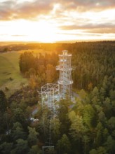 Observation tower surrounded by trees in golden sunlight, Himmelsglück observation tower with