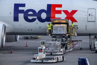 FedEx Express Boeing 777-FS2 cargo plane is unloaded, air freight container, air freight center at