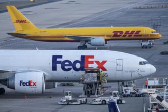 FedEx Express Boeing 777-FS2 cargo aircraft air freight containers are unloaded, DHL Boeing 757-200