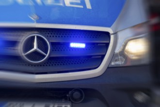 Symbolic image police operation: close-up of a blue light on a police car (digitally reworked)
