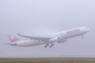 Swiss aircraft, HB-JHE Airbus A330-300, departure in fog, Zürich Kloten, Switzerland