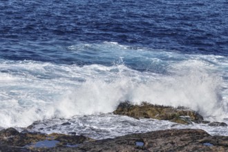 High waves break at full speed on a rocky coast, Yaiza Lanzarote