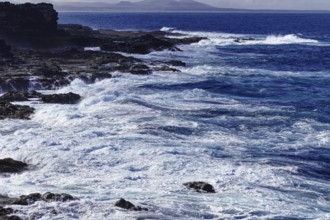 Thundering waves meet rocky coast under a cloudy sky, Yaiza Lanzarote
