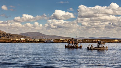 Traditional reed boats on a lake with a village on the shore under blue skies, The floating reed