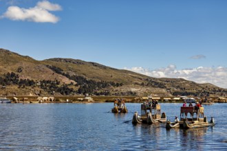 Traditional boats and people on a lake with a sweeping view of the shore, The floating reed islands