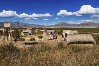 Extensive reed village in a natural setting with mountains, the floating reed islands of the Uros