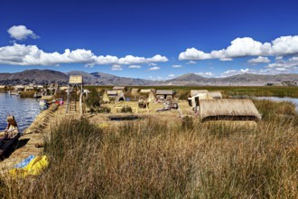 Natural environment with reed huts and mountains under blue skies, the floating reed islands of the