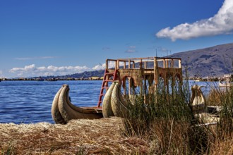 A traditional reed boat is lying on the shores of the lake under a cloudy sky, The floating reed