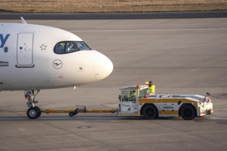 Lufthansa City Airbus A320neo is pushed from the gate onto the taxiway, ready to go, to