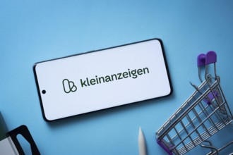 Dhaka, Bangladesh- 03 July 2025: Smartphone displaying Kleinanzeigen logo with shopping cart on a