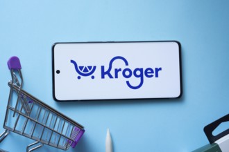 Dhaka, Bangladesh- 03 July 2025: Smartphone displaying Kroger logo with shopping cart on a blue