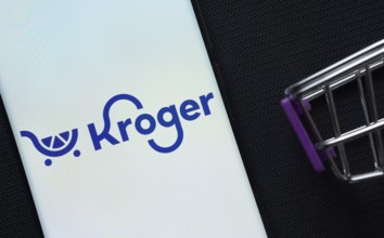 Dhaka, Bangladesh- 03 July 2025: A smartphone displaying the Kroger logo next to a miniature