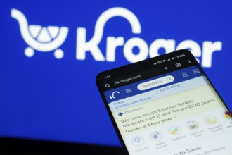 Dhaka, Bangladesh- 03 July 2025: Smartphone displaying Kroger web interface against Kroger logo