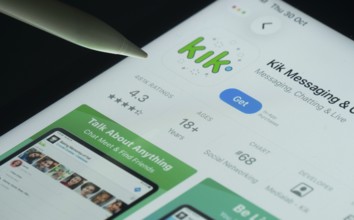 Dhaka, Bangladesh- 30 Oct 2025: Kik app on a iPad screen with a pen pointing at the install option